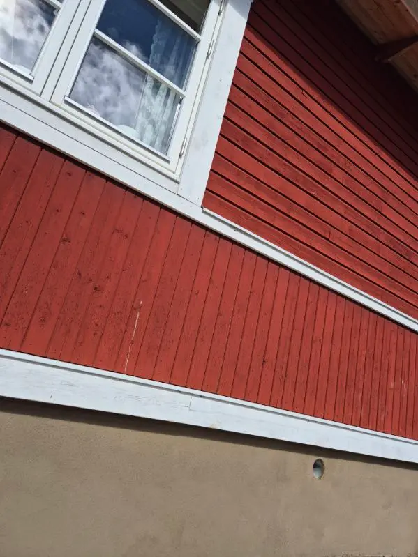 Putsad sockel under träfasad efter renovering
